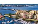 Stunning aerial view of waterfront condos, yachts, and bridges under a sunny sky at 610 Riviera Dunes Way # 308, Palmetto, FL 34221