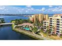 Beautiful aerial view of condos with community pool, waterway, and bridge in the distance at 610 Riviera Dunes Way # 308, Palmetto, FL 34221