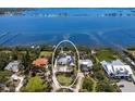 Panoramic aerial view of the waterfront property surrounded by lush greenery, showcasing its prime location and neighborhood at 705 89Th Nw Ct, Bradenton, FL 34209