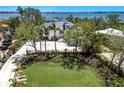 Elegant residence with a well-manicured lawn, mature trees, and a circular driveway providing ample parking space at 705 89Th Nw Ct, Bradenton, FL 34209