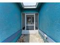 A blue house featuring a screened front door area with a pebble lined entrance at 7810 34Th E Ct, Sarasota, FL 34243