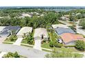 Aerial view of a neighborhood with mature trees and well-maintained homes near a large lake at 8408 Whispering Woods Ct, Lakewood Ranch, FL 34202