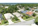 Aerial view of a neighborhood showcasing the tile roofs and green spaces surrounding the homes at 8408 Whispering Woods Ct, Lakewood Ranch, FL 34202