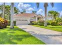 Charming home featuring a well-manicured lawn and beautiful tropical landscaping at 8604 15Th Nw Ave, Bradenton, FL 34209