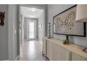 Hallway with decorative artwork and contemporary console table at 10414 Spring Tide Way, Parrish, FL 34219