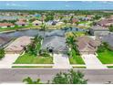 Aerial view of a neighborhood featuring homes with waterfront views and lush green lawns at 11342 77Th E St, Parrish, FL 34219