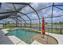 Screened-in pool features a spa and water feature, with a view of the serene lake at 11342 77Th E St, Parrish, FL 34219