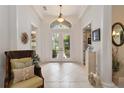 Bright foyer with soaring ceilings, tiled floor, and double doors leading to the outdoors at 12240 Thornhill Ct, Lakewood Ranch, FL 34202