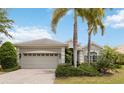 Charming home showcasing a pristine lawn, palm trees, and a well-kept exterior at 12240 Thornhill Ct, Lakewood Ranch, FL 34202