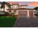 Gorgeous Mediterranean home with a three-car garage and a paved driveway at 13706 American Prairie Pl, Lakewood Ranch, FL 34211