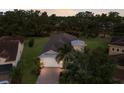 Aerial view of home showcasing its manicured surroundings, mature trees, and a well-maintained tile roof at 13848 American Prairie Pl, Lakewood Ranch, FL 34211