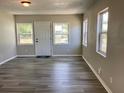 Bright living room showcasing modern gray flooring and ample natural light from multiple windows at 1512 18Th W Ave, Bradenton, FL 34205