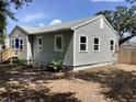 Picture of the side of the home showing siding, windows, and the blue front door at 1512 18Th W Ave, Bradenton, FL 34205