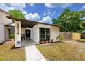 Inviting home entrance with a comfortable porch, and well-maintained landscaping at 15718 Squirrel Tree Pl, Tampa, FL 33624