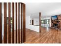 Open concept living area with fireplace, wood floors, and a view to sunroom at 15718 Squirrel Tree Pl, Tampa, FL 33624