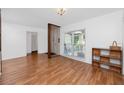 Bright living area featuring wood floors, natural light, and neutral paint scheme at 15718 Squirrel Tree Pl, Tampa, FL 33624