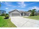 Lovely one story home has an attached two-car garage and concrete driveway at 168 Wading Bird Dr, Venice, FL 34292