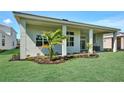 Covered outdoor living space, featuring a built-in outdoor kitchen area overlooking a well-maintained lawn at 17719 Palmiste Dr, Bradenton, FL 34202