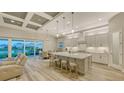 Spacious eat-in kitchen featuring granite counters, stainless appliances, light wood floors and recessed ceiling with beams at 17811 Roost Pl, Bradenton, FL 34211