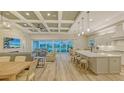Bright, open-concept living space with a kitchen island and sliding doors with outdoor views at 17811 Roost Pl, Bradenton, FL 34211
