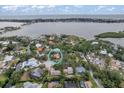 Aerial view of a waterfront home surrounded by lush greenery, with bay views and beautiful landscape at 1809 Buccaneer Ter, Sarasota, FL 34231