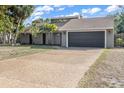 Charming home featuring a two-car garage, modern architectural details and mature palm trees at 1809 Buccaneer Ter, Sarasota, FL 34231