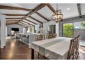 Open concept kitchen with wooden beams, an island with barstool seating, and stainless steel appliances at 1809 Buccaneer Ter, Sarasota, FL 34231