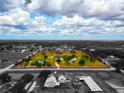 Stunning aerial view showcasing the expansive property with a house, barn, pond, and lush greenery at 22803 67Th E Ave, Bradenton, FL 34211