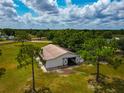 Spacious barn with high ceilings and a large open entrance, surrounded by lush greenery and mature trees at 22803 67Th E Ave, Bradenton, FL 34211