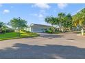 Wide street shot of a well-landscaped single-story home in a quiet neighborhood at 2607 Lancaster Dr # 35, Sun City Center, FL 33573