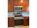A kitchen with stainless steel appliances and updated cabinets at 2616 Hidden Lake N Dr # A, Sarasota, FL 34237