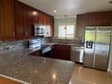 Modern kitchen with stainless steel appliances and granite countertops at 2616 Hidden Lake N Dr # A, Sarasota, FL 34237
