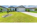 Single-story home featuring a well-maintained lawn, fresh landscaping, and a two-car garage at 2926 61St E Dr, Ellenton, FL 34222