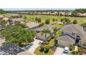 An aerial view of the house with mature landscaping and golf course community at 315 Heritage Isles Way, Bradenton, FL 34212