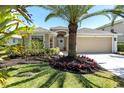 Charming single-story home with well-manicured landscaping and a two-car garage at 315 Heritage Isles Way, Bradenton, FL 34212