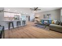 Open-concept living space with modern decor, connecting the kitchen and living area, and featuring hardwood floors at 3193 Bellevue St, Sarasota, FL 34237