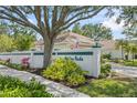 Ashley Oaks community entrance, featuring lush landscaping and an American flag at 3263 Woodberry Ln # Lot 15, Sarasota, FL 34231