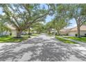 A tree-lined street showcasing well-maintained homes in a quiet neighborhood at 3263 Woodberry Ln # Lot 15, Sarasota, FL 34231