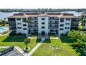Exterior view of condos featuring well-maintained landscaping and private balconies at 3540 Gulf Of Mexico Dr # 303, Longboat Key, FL 34228