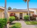 Charming home featuring lush landscaping, a tiled roof, and a welcoming front entrance at 3627 Longmeadow # 39, Sarasota, FL 34235