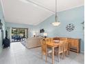 Bright and airy living room with vaulted ceilings and sliding glass doors to screened lanai at 3627 Longmeadow # 39, Sarasota, FL 34235