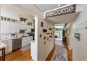 Hallway view of eat-in kitchen featuring a modern backsplash and stainless steel appliances at 3803 E Bay Dr # 10, Bradenton Beach, FL 34217