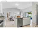 Stylish kitchen featuring stainless steel appliances, granite countertops, and an open layout to the living area at 416 Delaney St, Port Charlotte, FL 33954