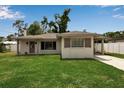 Inviting single-story home with a cozy front porch and manicured lawn at 417 20Th W Ave, Palmetto, FL 34221