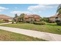 A charming single-story home with lush landscaping and a terracotta roof at 431 Fieldstone Dr, Venice, FL 34292