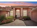 Charming home's front entrance with double doors, brick walkway, and evening sky at 431 Fieldstone Dr, Venice, FL 34292