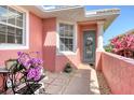 Inviting front entrance with a decorative wreath, vibrant flowers, and a charming seating area at 4322 Reflections Pkwy, Sarasota, FL 34233