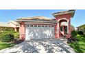 Attractive single-Gathering home showcasing a well-manicured lawn, lush landscaping, and a convenient two-car garage at 4322 Reflections Pkwy, Sarasota, FL 34233