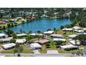 Aerial view of a home near a lake surrounded by lush greenery and other homes at 445 Matisse S Cir # 445, Nokomis, FL 34275
