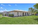 Low-angle shot of a well-maintained single-story home with a lush green lawn at 445 Matisse S Cir # 445, Nokomis, FL 34275